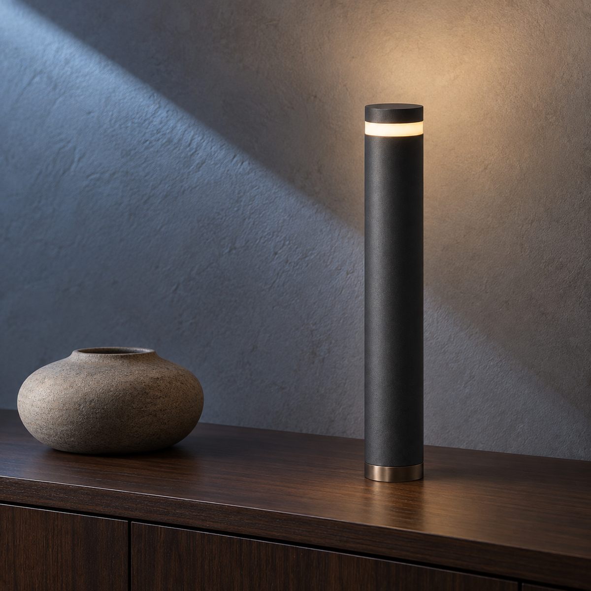 Cinder Column Light on a dark wood sideboard